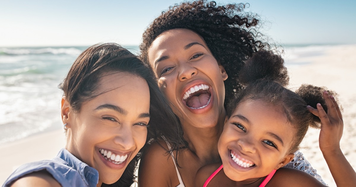 Family smiling on the beach