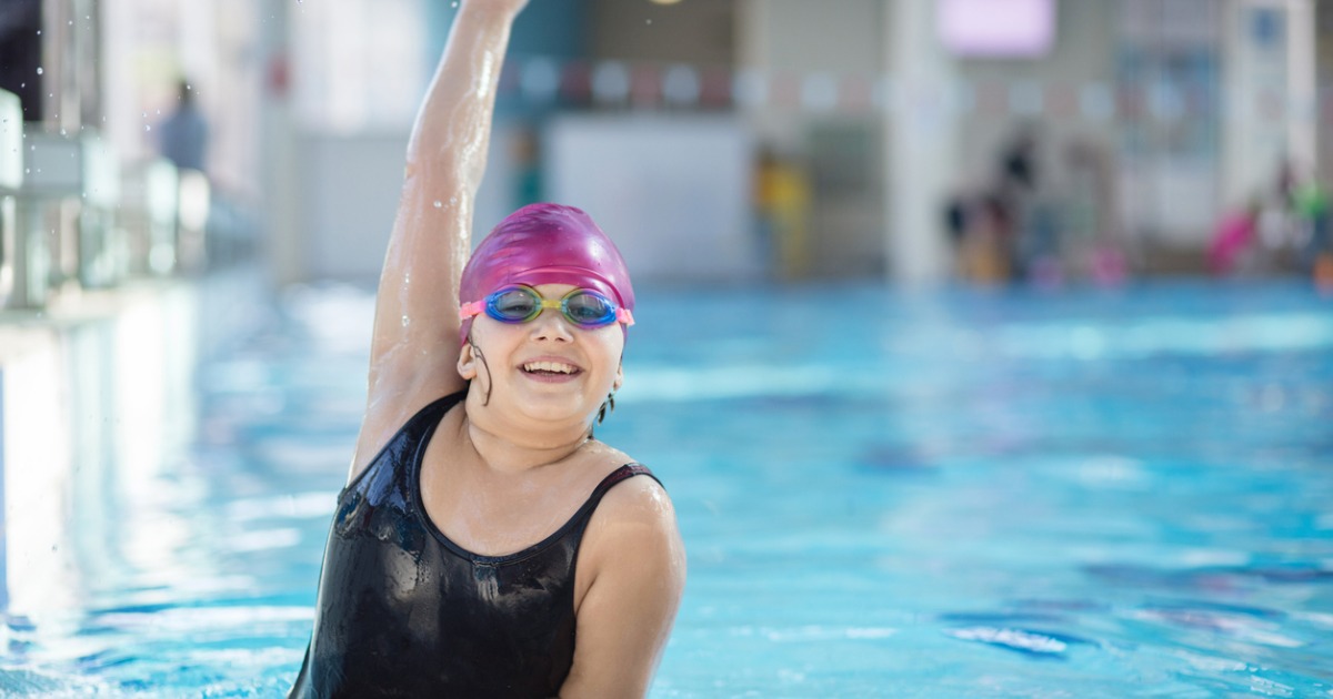 Young girl poses in the pool