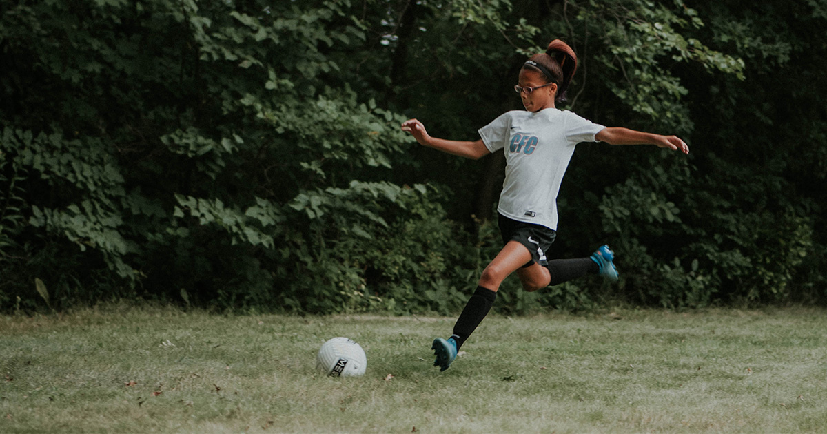 A young girl plays soccer