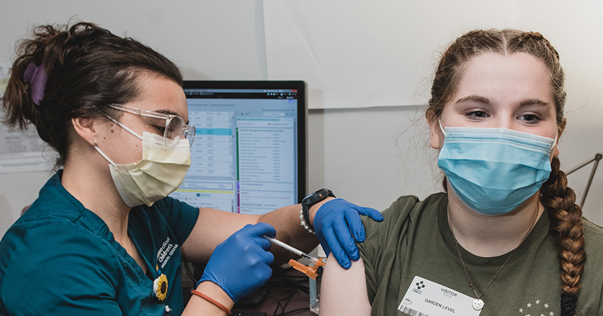 A teen getting a flu shot