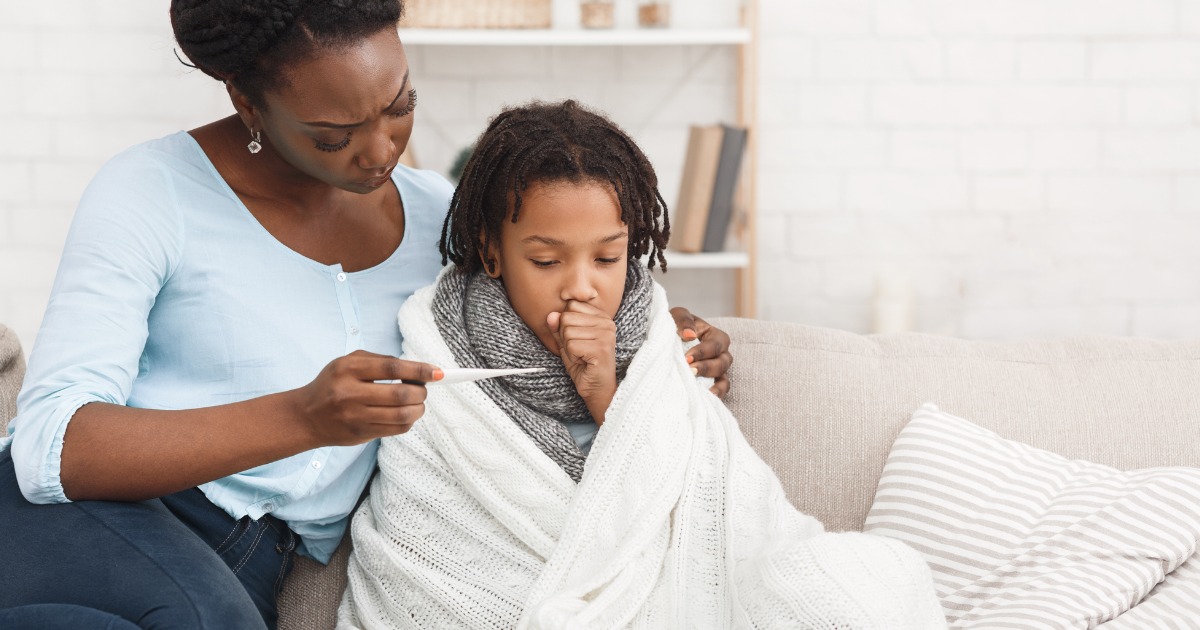 Mother measuring daughters temperature