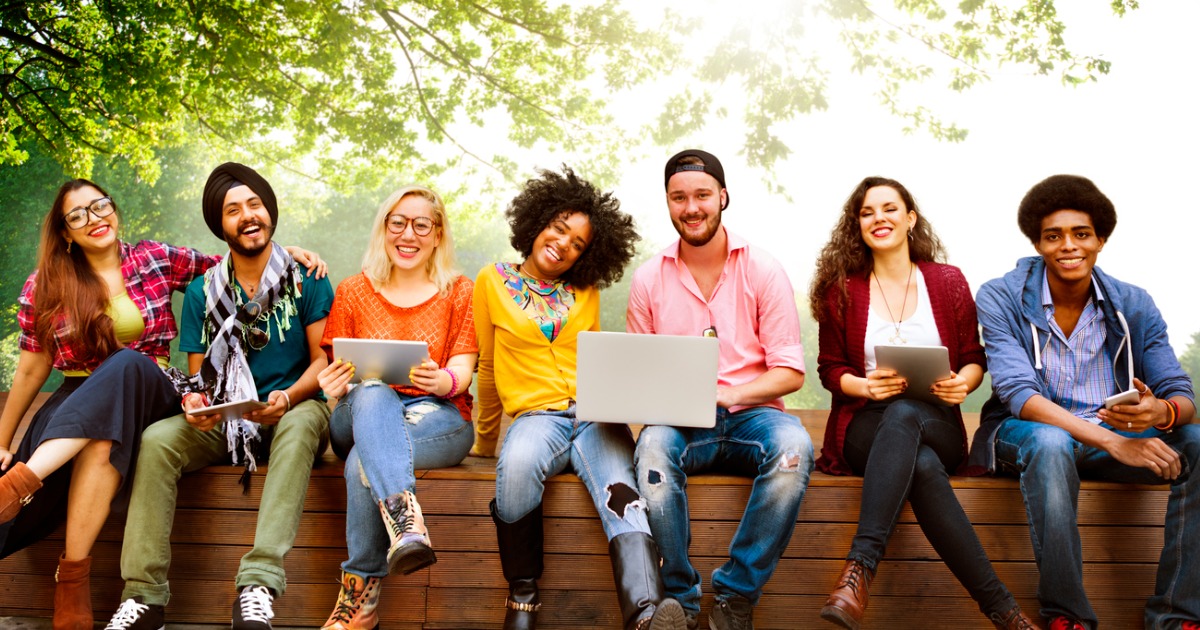 Adults sitting on wooden wall