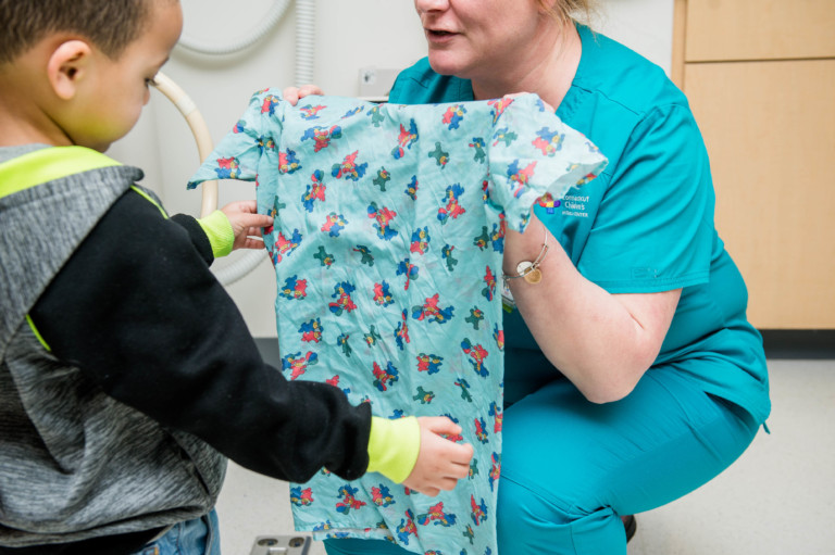 nurse showing patient his scrub