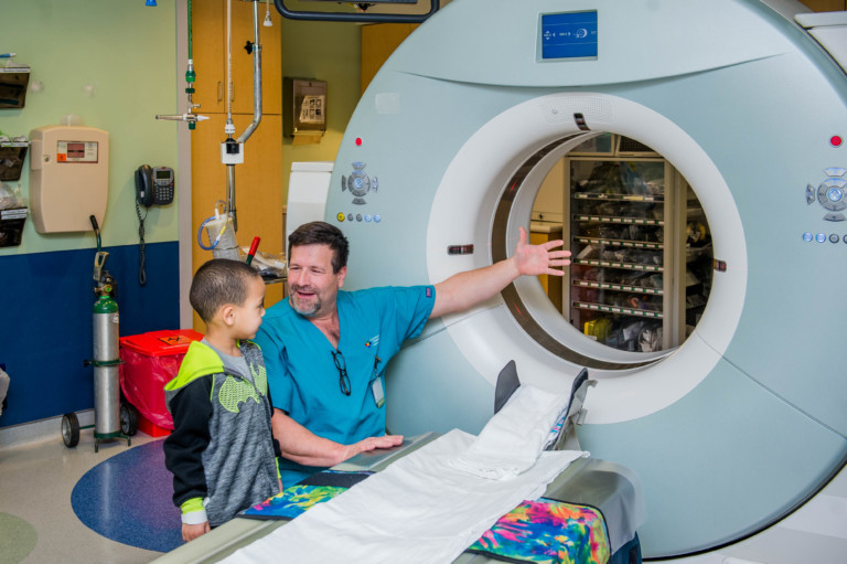 physician introducing MRI machine to patient