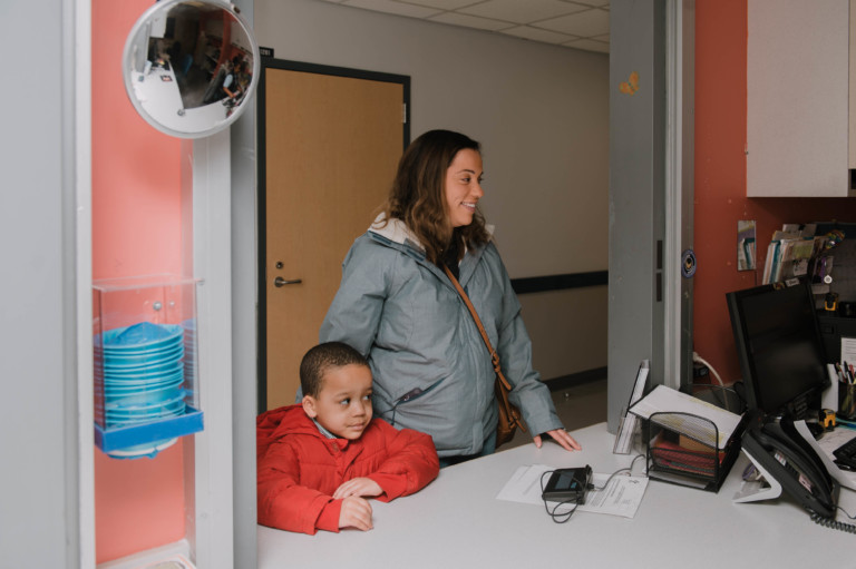 patient at registration desk with parent