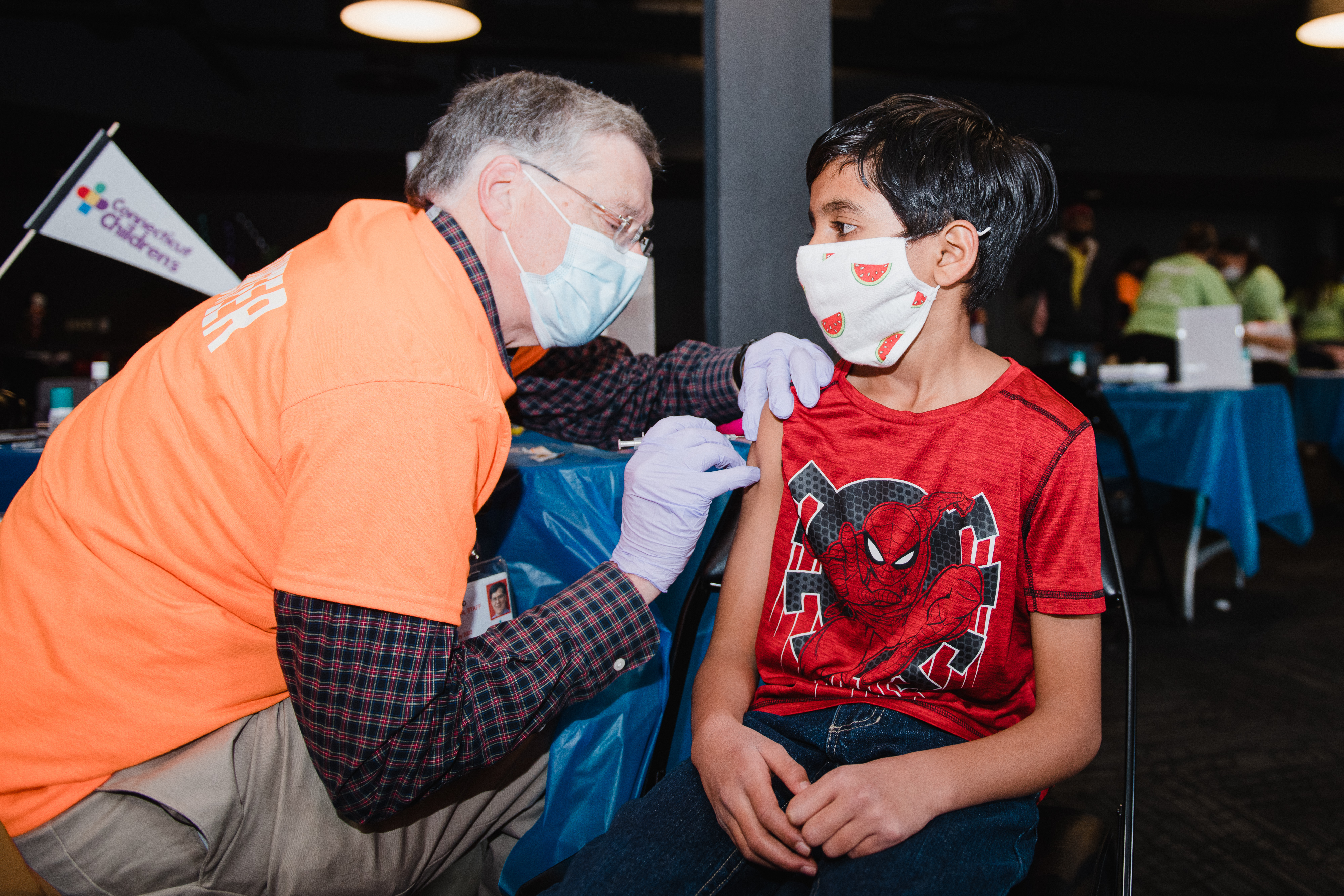 Child receiving a vaccine at the covid vaccine event.