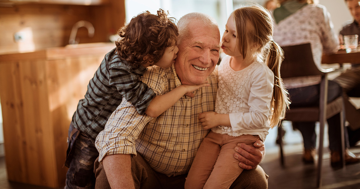 Two young children with their grandpa