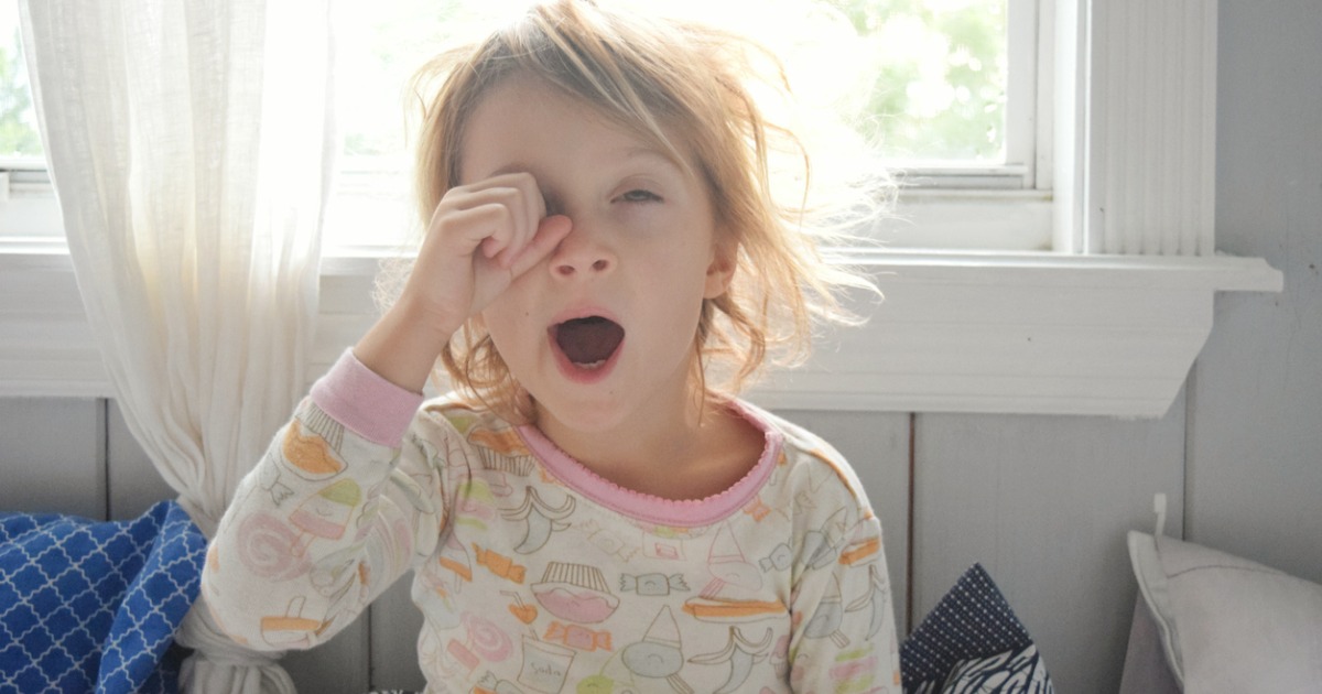 Young girl yawning