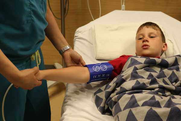 patient's blood pressure is being checked