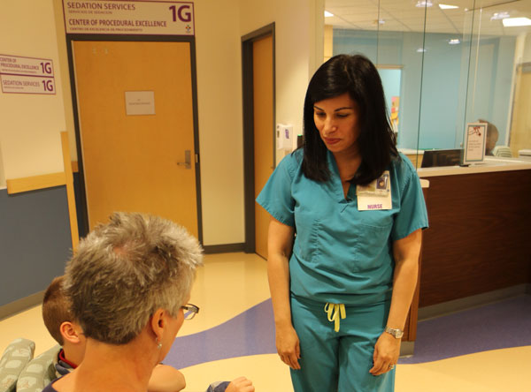 nurse greeting patient and family