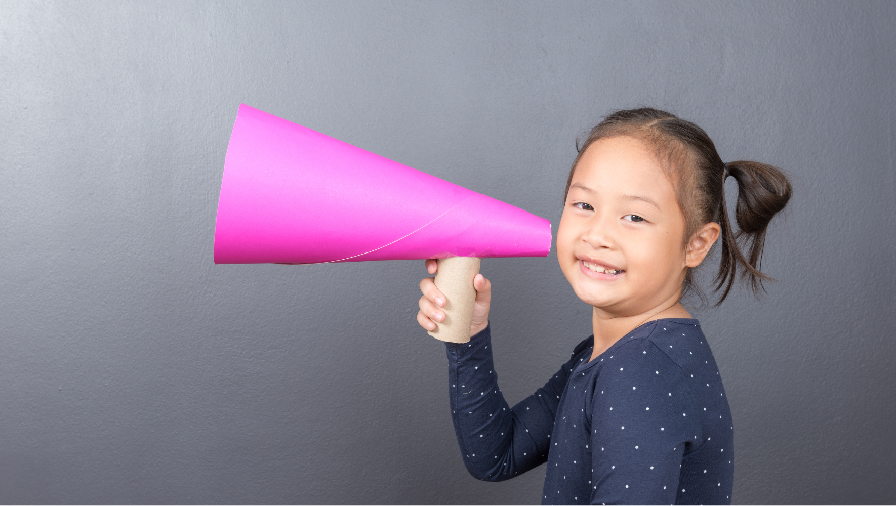 child holding up a pretend microphone