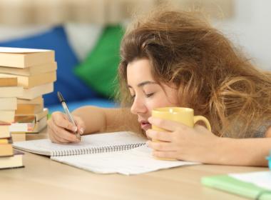 Exhausted college student passing out on homework