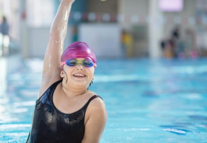 Young girl poses in the pool