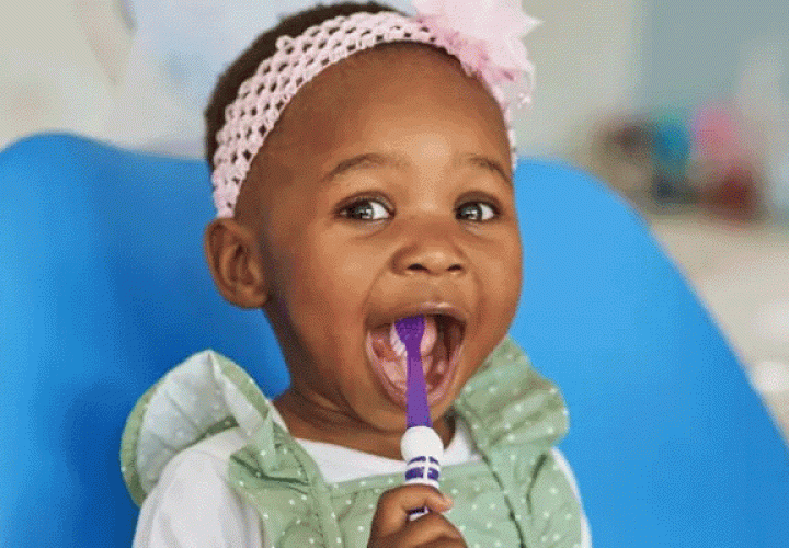 Girl with toothbrush in her mouth