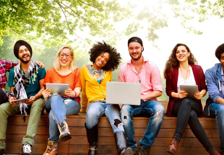 Adults sitting on wooden wall