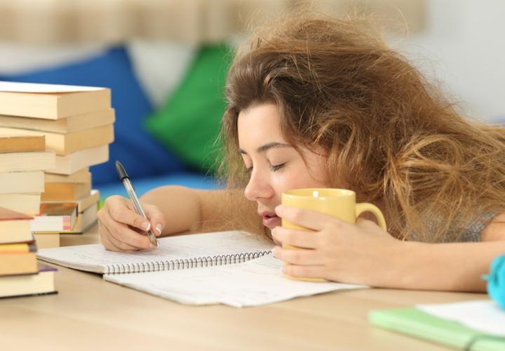 Exhausted college student passing out on homework