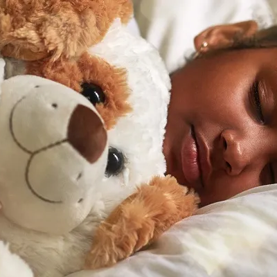 Girl sleeping with a teddy bear