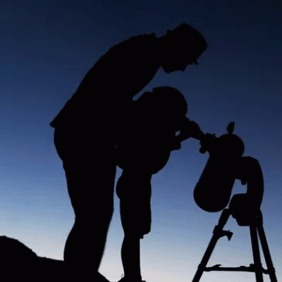 Dad and child looking through a telescope