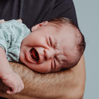 Newborn screams inconsolably in dad's arms