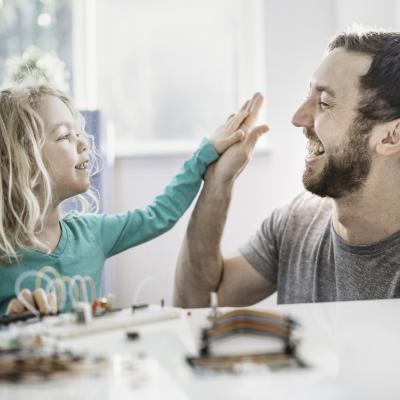 Father and son high fiving.