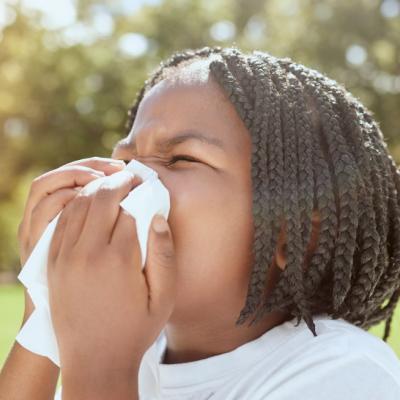 Child blowing nose outside, summer safety tips for those nose